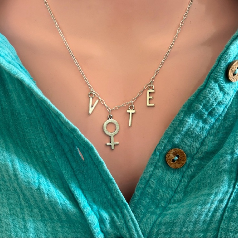 Silver tone “vote” necklace with female symbol.